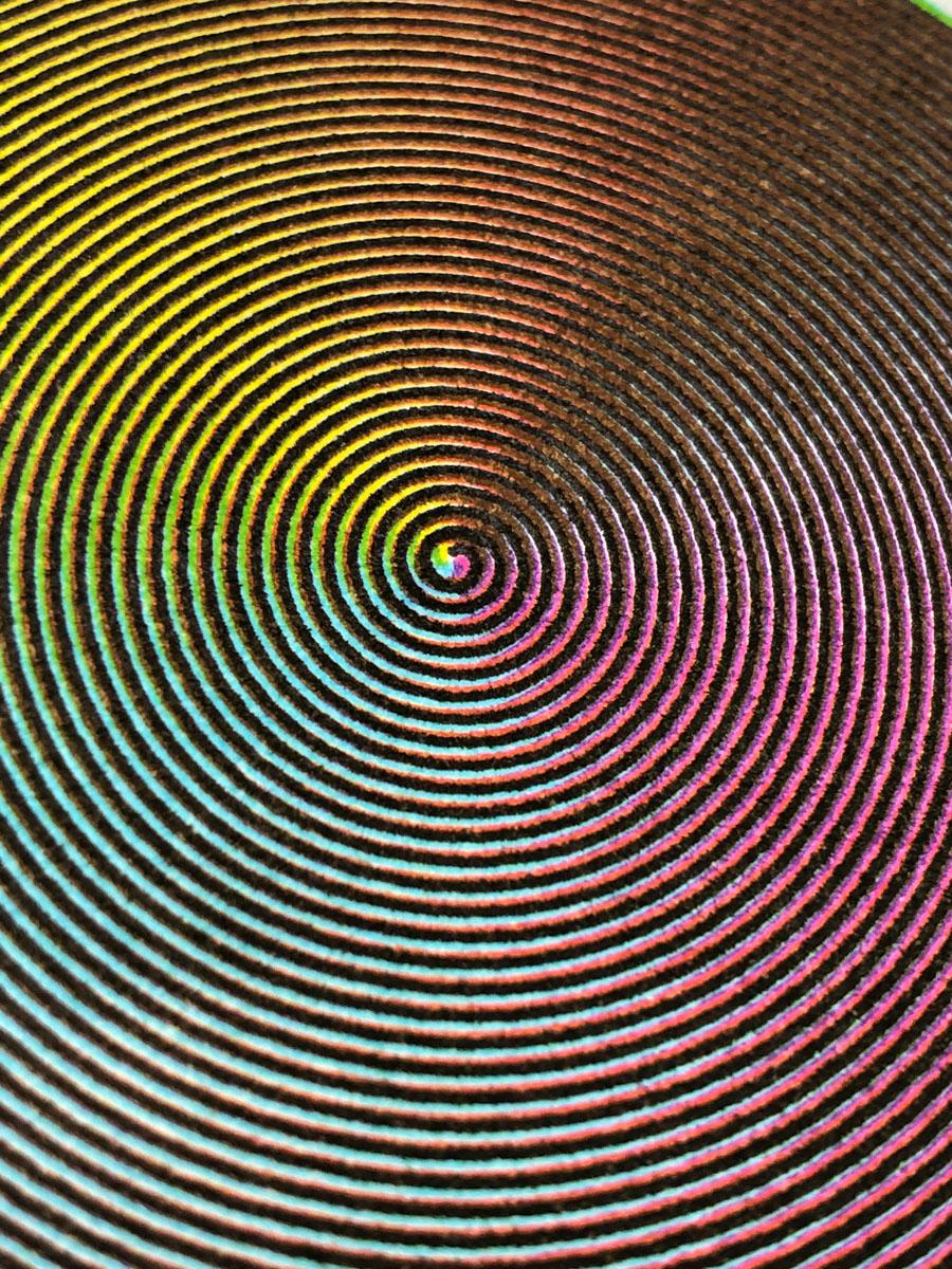 An extreme closeup of the center of one of the spirals. The start point of each of the four lines are visible