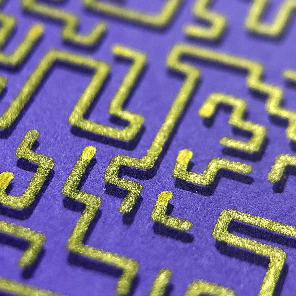 A close view of gold lines on purple paper. The lines move with random 90 degree rotations, but do not overlap. Some are short, others long enough to leave the frame of the image